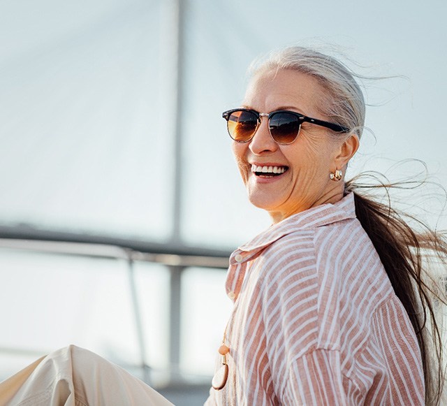 Senior woman smiling while relaxing on boat