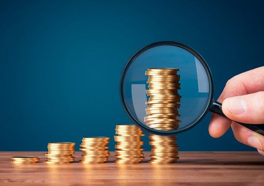 Coins examined with magnifying glass