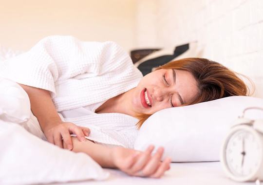 Woman grinding her teeth while sleeping
