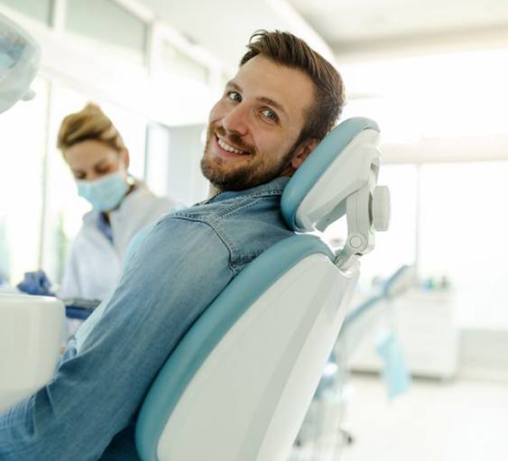 Exhausted man sitting at his work desk