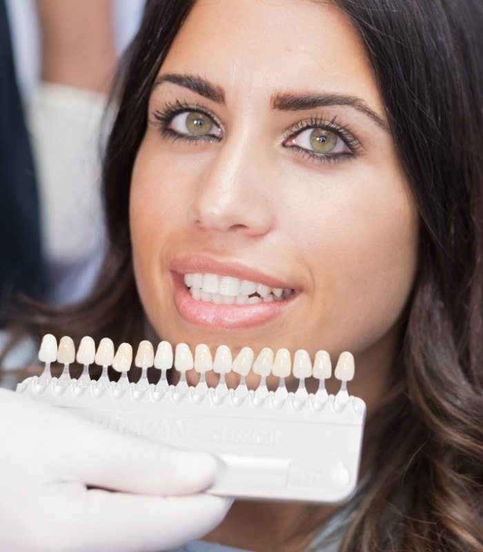 Woman trying on dental veneers from her cosmetic dentist in Owasso