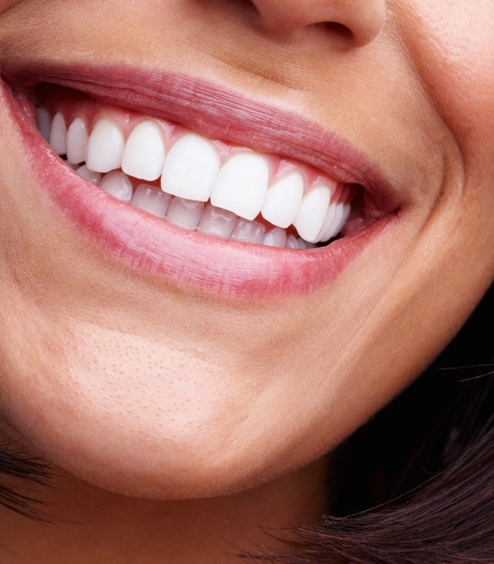 Close up of person with straight white teeth smiling