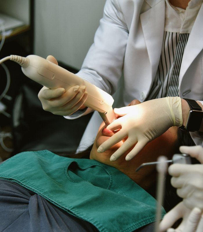 Dentist taking digital dental impressions of a patient