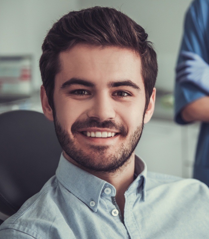 Man smiling in dental chair at Owasso dental office