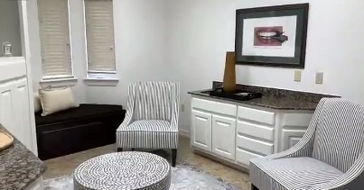 Black and white armchairs next to sink in dental office