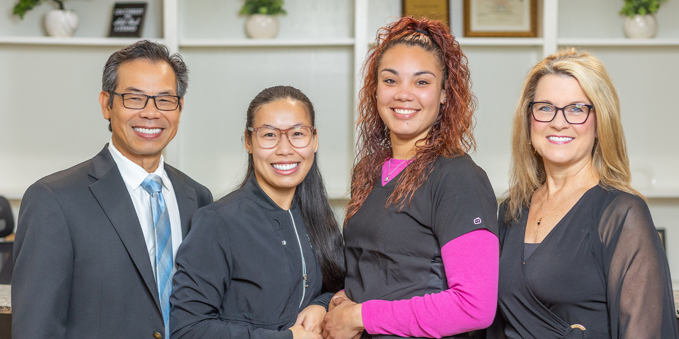 Doctor Lim with three Owasso dental team members