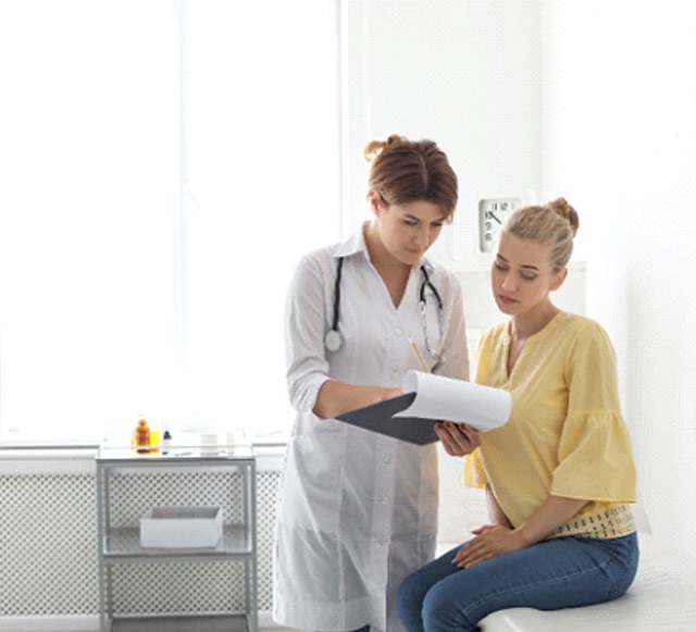 Doctor and patient looking at clipboard together