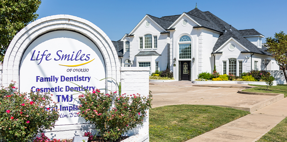 Life Smiles of Owasso sign in front of Owasso dental office building