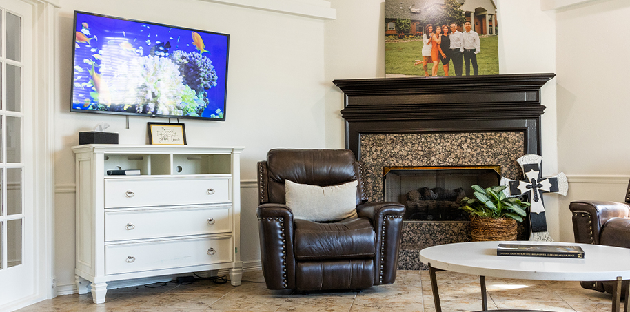 T V screen with fish on wall of reception area