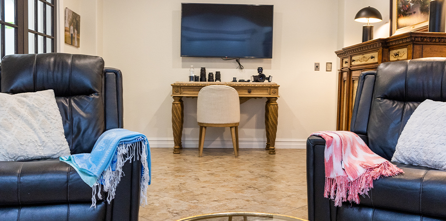 Two black leather armchairs in reception area