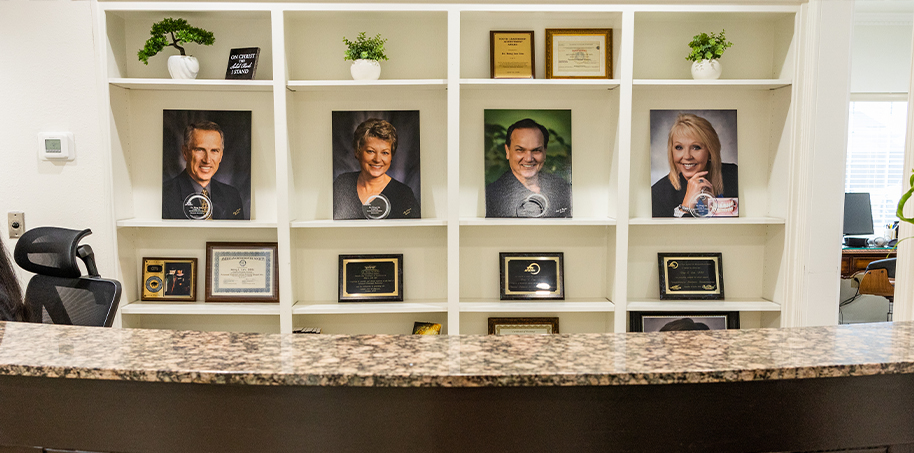 Front desk with photos of people in background