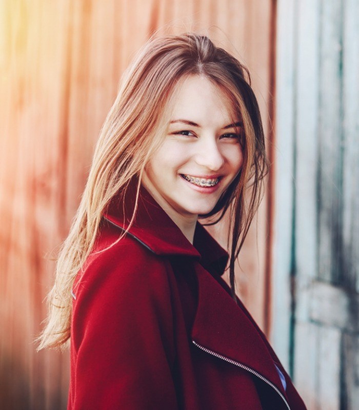 Young woman smiling with braces in Owasso