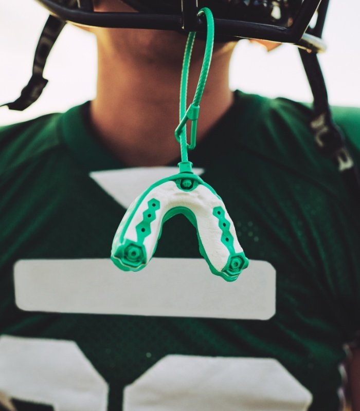 Athletic mouthguard hanging from a football helmet