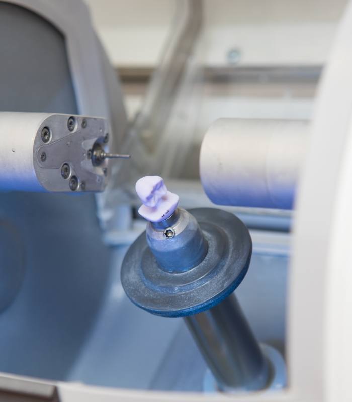 Milling machine creating a same day dental crown from small ceramic block