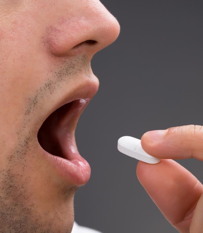 Close up of person taking pill for oral conscious sedation dentistry in Owasso