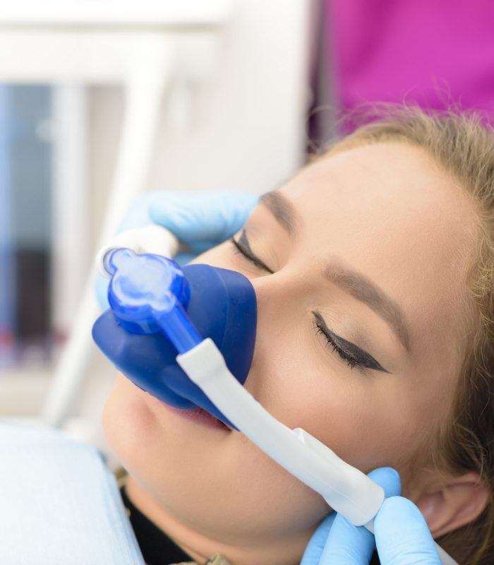 Dental patient wearing nitrous oxide sedation mask