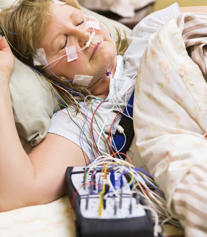 Sleeping woman hooked up to multiple electrodes