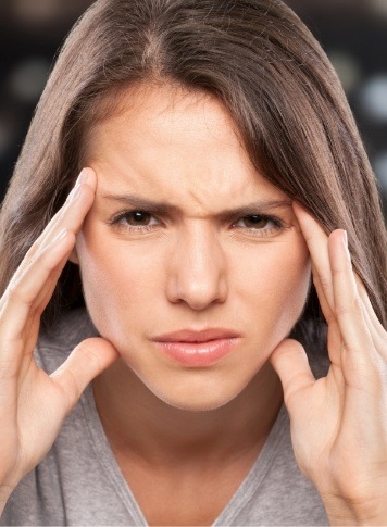 Frustrated woman touching her temples in pain