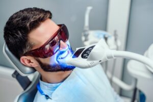 Patient having teeth whitened at the dentist. 
