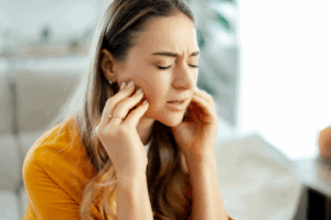 a patient grimacing due to jaw pain