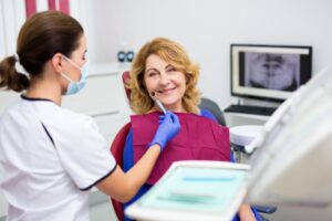 Woman smiling after her full mouth reconstruction